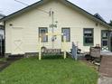 Rear exterior of home featuring a wooden swing set and small grassy yard at 1546 Wade St, Indianapolis, IN 46203