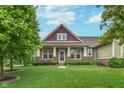 Charming home with a manicured lawn, professional landscaping, and a welcoming front porch at 16071 Prince Ct, Noblesville, IN 46062