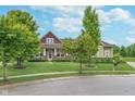 Charming home with a manicured lawn, professional landscaping, and mature trees in a suburban setting at 16071 Prince Ct, Noblesville, IN 46062