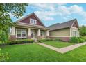 Charming home with a manicured lawn, professional landscaping, and a welcoming front porch at 16071 Prince Ct, Noblesville, IN 46062