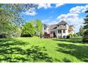Expansive backyard featuring a lush lawn and mature trees, perfect for outdoor activities and relaxation at 16316 Brookhollow Dr, Westfield, IN 46074