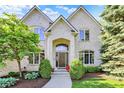 Charming brick home with manicured landscaping, a classic arched entryway, and a neatly paved walkway at 16316 Brookhollow Dr, Westfield, IN 46074