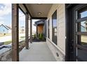 View of the front porch with exposed wood columns and view of the neighborhood at 17339 Newton Main St, Westfield, IN 46074