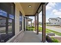 Relaxing covered porch with stained wood posts and views of the landscaped yard at 17339 Newton Main St, Westfield, IN 46074