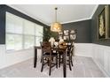Cozy dining area showcases a wooden table, chairs, and a decorative light fixture above, complemented by stylish wall decor at 18763 Abigail Cir, Westfield, IN 46062