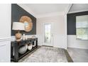 Welcoming entryway featuring a decorative table, stylish mirror, and elegant wainscoting that accentuates the space at 18763 Abigail Cir, Westfield, IN 46062