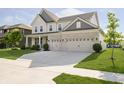 Beautiful two-story home boasts a wide driveway leading to a three-car garage and well-kept landscaping at 18763 Abigail Cir, Westfield, IN 46062