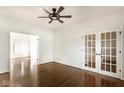 Bright room with dark hardwood floors, a modern ceiling fan, and elegant french doors at 197 Ceejay Dr, Greenwood, IN 46142