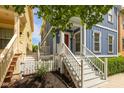 Charming blue home with a welcoming white porch, red door, and lush green landscaping at 2075 Rhettsbury St, Carmel, IN 46032