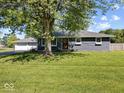 Charming home with a lush lawn, mature shade tree, and an inviting front exterior at 2233 S Miller Ave, Shelbyville, IN 46176