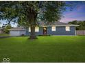 Charming single-story home with beautiful lawn, mature shade tree, and well-maintained front exterior at 2233 S Miller Ave, Shelbyville, IN 46176