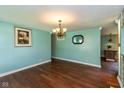 Open dining area with hardwood floors and stylish lighting fixture at 2519 N Boehning St, Indianapolis, IN 46219