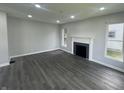 Bright living room with modern gray floors, fireplace, and ample natural light from windows at 2911 E 35Th St, Indianapolis, IN 46218
