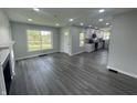 Open-concept living space featuring new floors, a fireplace, and an eat-in kitchen at 2911 E 35Th St, Indianapolis, IN 46218