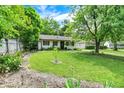 Lovely home featuring a spacious green lawn and mature trees that provide ample shade at 332 Campus Ln, Indianapolis, IN 46219