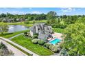 Expansive property features a luxurious pool, pristine pond with fountain, and lush green landscape at 3398 Nottinghill Blvd, Plainfield, IN 46168