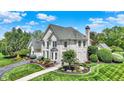 Beautiful brick home showcases meticulous landscaping, well-manicured lawn, and architectural details at 3398 Nottinghill Blvd, Plainfield, IN 46168