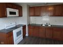 Updated kitchen with stainless steel sink, granite countertops, and new white appliances at 4353 Evanston Ave, Indianapolis, IN 46205
