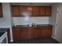 Updated kitchen featuring a stainless steel sink, dark countertops, and tile backsplash at 4353 Evanston Ave, Indianapolis, IN 46205