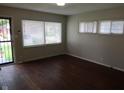 Bright living room with original hardwood floors and natural light from several windows at 4353 Evanston Ave, Indianapolis, IN 46205
