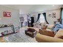 Bright living room with hardwood floors, cozy seating, and an open floor plan at 4415 N Longworth Ave, Indianapolis, IN 46226