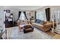 Cozy living room with dark curtains, a large window, and comfortable furniture at 4415 N Longworth Ave, Indianapolis, IN 46226