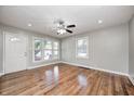 Spacious living room featuring hardwood floors, a ceiling fan and plenty of natural light at 4621 E 17Th St, Indianapolis, IN 46218