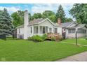 Well-maintained home with a large, manicured lawn, showcasing its curb appeal and neighborhood setting at 4641 Ralston Ave, Indianapolis, IN 46205
