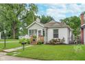 Attractive home with a cozy porch, garden, and a well-maintained lawn enhancing its charm at 4641 Ralston Ave, Indianapolis, IN 46205