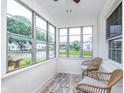 Bright sunroom featuring large windows, wicker seating, and a cozy rug at 4641 Ralston Ave, Indianapolis, IN 46205