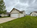 View of home with attached two-car garage on a neatly manicured lawn at 509 Woodberry Dr, Danville, IN 46122