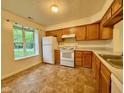 Functional kitchen featuring white appliances and wood cabinetry at 509 Woodberry Dr, Danville, IN 46122
