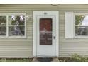 Close up of a front door with sidelight windows and vinyl siding at 521 Elmhurst Pl, Whiteland, IN 46184