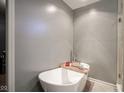 Elegant bathroom features a standalone soaking tub and modern fixtures, creating a spa-like atmosphere at 5374 John Quincy Adams Ct, Plainfield, IN 46168