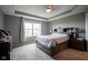 Comfortable bedroom featuring a large window for natural light and a bed with storage drawers at 5374 John Quincy Adams Ct, Plainfield, IN 46168