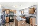 Bright kitchen features wood cabinets, a modern island, and plenty of storage space. Ready for meal prep at 5671 Glass Chimney Ln, Indianapolis, IN 46235