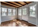 Bright sun room with hardwood floors, wood ceilings and multiple windows at 6264 Central Ave, Indianapolis, IN 46220