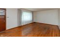 Bright living room with hardwood floors, a front window with natural light and a wood door at 6498 N County Road 475 E, Pittsboro, IN 46167