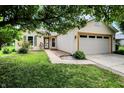 Charming single-story home featuring a two-car garage and well-maintained lawn and landscaping at 7061 Blankenship Ave, Indianapolis, IN 46217