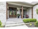 Inviting front porch with elegant double doors, decorative wreaths, and comfortable seating area at 7648 Killarney Dr, Indianapolis, IN 46217