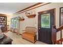 Inviting entryway with wood floors, decorative shelves, and a charming bench at 7978 Park Meadows Dr, Brownsburg, IN 46112