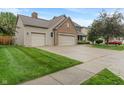 View of a charming two-story home with a three-car garage and well-maintained lawn at 7978 Park Meadows Dr, Brownsburg, IN 46112