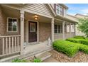 Welcoming front porch with brick accents, decorative columns, and a cozy seating area at 7978 Park Meadows Dr, Brownsburg, IN 46112