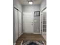 Inviting entryway featuring wood-look flooring, neutral paint and ample closet space at 8241 Morera Ct, Indianapolis, IN 46237