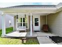 Inviting front porch with seating area, perfect for enjoying the outdoors and neighborhood views at 8325 Chesterhill Ln, Indianapolis, IN 46239