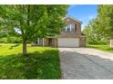 Beautiful two-story brick home with a two-car garage and a well-maintained front yard at 8631 Belle Union Pl, Indianapolis, IN 46113