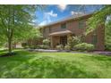 Beautiful brick home with lush landscaping, a well-kept lawn, and a welcoming front porch at 876 Box Turtle Ct, Columbus, IN 47201
