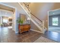 Spacious foyer with tile flooring, staircase, and decorative furniture, creating a welcoming ambiance at 876 Box Turtle Ct, Columbus, IN 47201