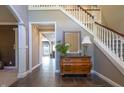 Inviting foyer with tiled floors, staircase, and decorative furniture showcasing the home's elegant entry at 876 Box Turtle Ct, Columbus, IN 47201