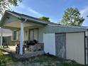 This home has a cozy front porch, adding curb appeal and outdoor living space at 8936 E 46Th St, Indianapolis, IN 46226